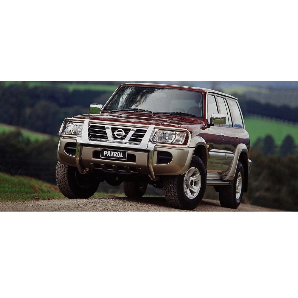 An Old Man Emu-equipped Patrol Y61 (99-09) with the OME 2 inch Lift Kit is parked on a dirt road, showcasing its impressive ground clearance.