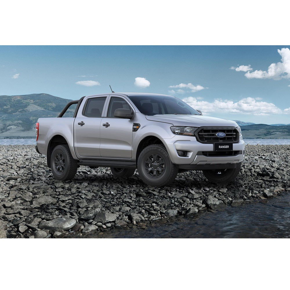 The 2019 Ford Ranger, equipped with the OME 2 inch Lift Kit for Ranger PX3 (18-ON) by Old Man Emu, is parked on a rocky beach.