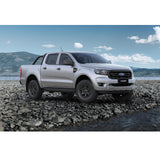 The 2019 Ford Ranger, equipped with the OME 2 inch Lift Kit for Ranger PX3 (18-ON) by Old Man Emu, is parked on a rocky beach.
