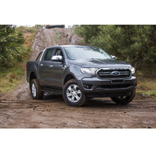 Load image into Gallery viewer, The 2019 Old Man Emu Ranger, equipped with an exceptional ground clearance, is parked on a dirt road.