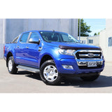 A blue Ford Ranger with impressive ground clearance and equipped with Old Man Emu Nitrocharger shocks, parked in front of a building.