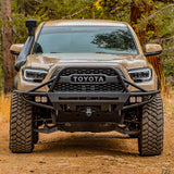 The front end of a Toyota Tacoma with enhanced ground clearance thanks to the OME 3 inch Lift Kit for Tacoma (16-23) by Old Man Emu suspension system.