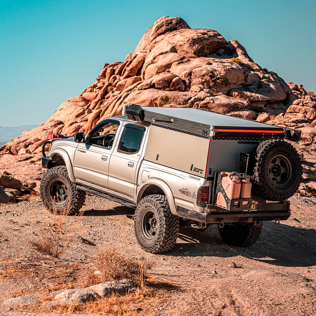 An Old Man Emu 2 inch Lift Kit for Tacoma (98-04) with an enhanced suspension articulation parked on a rock in the desert.