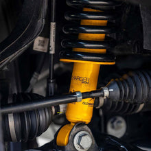 Load image into Gallery viewer, A yellow OME 2.5 inch Essentials Lift Kit for Tundra (07-21) from the Old Man Emu suspension system is attached to a vehicle, providing increased ground clearance.