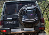 Dobinsons 70L Tire Trash & Storage Bag (Pg00 - 2330) mounted on rear tire of off-road SUV with heavy-duty PVC construction