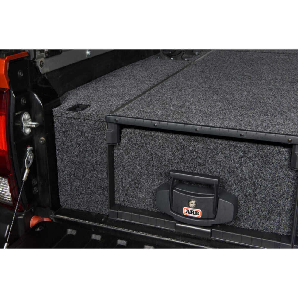 A truck bed with an ARB Outback Solutions Roller Drawer RD945 featuring an anti-rattle design.
