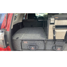 Load image into Gallery viewer, The ARB Outback Solutions Roller Drawer RD945 is a reliable and durable vehicle that offers maximum security. Its anti-rattle design ensures a smooth and quiet ride, while the UV stable commercial carpet adds an extra layer of protection.