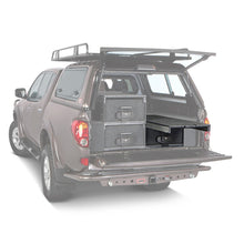 Load image into Gallery viewer, The back of a brown pickup truck with an ARB Outback Solutions Roller Drawer &amp; Roller Floor RDRF945.