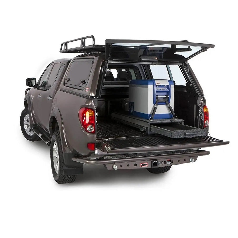 The back of a truck with an ARB Outback Solutions Mid-Height Roller Floor RFH945 in it, featuring maximum security and dust resistant properties.