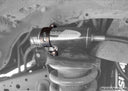 Dobinsons Reservoir Mount Kit For Front Of Land Cruiser 105 Series - RM59-030 heavy-duty steel brackets installed on suspension coil spring assembly