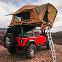 ARB Flinders Rooftop Tent 803300A mounted on 2023 Jeep Wrangler with rugged terrain tires and rear ladder access.