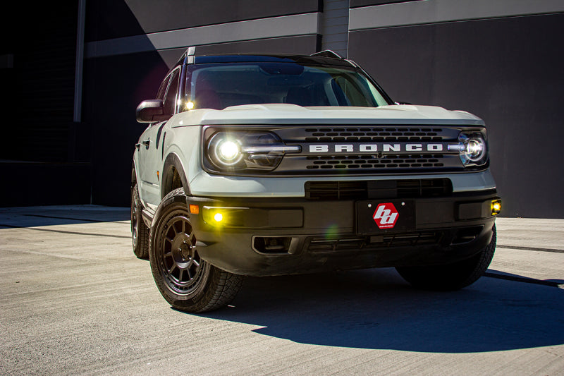 Baja Designs 21+ Ford Bronco Sport Squadron Pro Spot LED Light Pods - Clear mounted on front bumper with amber illumination