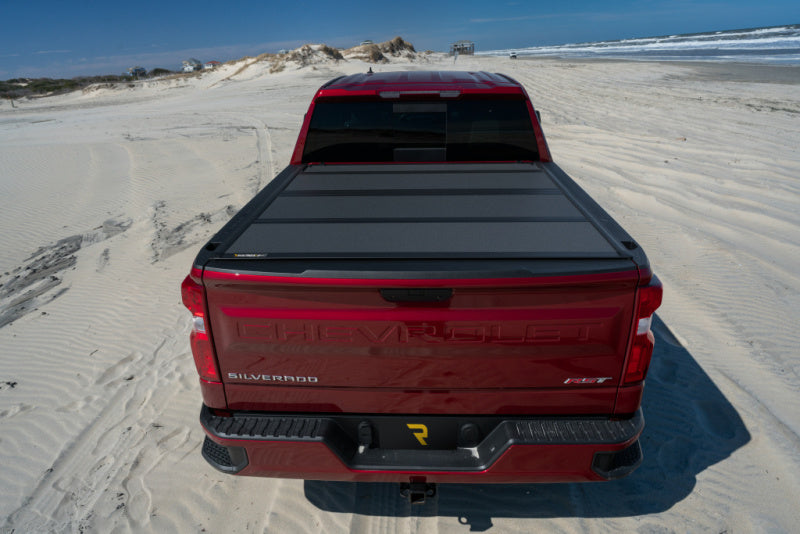 BAK BAKFlip MX4 Hard Folding Tonneau Cover 448446 on red 2024 Toyota Tacoma with durable low-profile bed protection