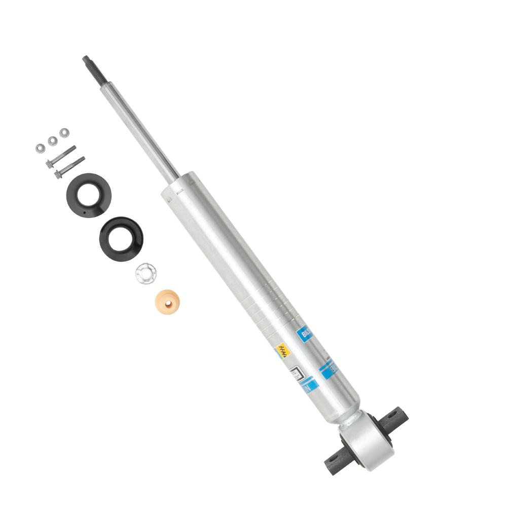 Heavy-duty monotube shock absorber with mounting hardware, bushings, washers, and nuts on a white background