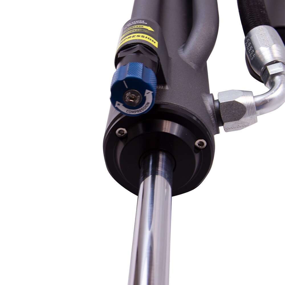 A close up of a hydraulic hose with Bilstein B8 8100 Bypass Rear Left Shock Absorber bil25-320442 for Toyota Tacoma 05-23 attached.