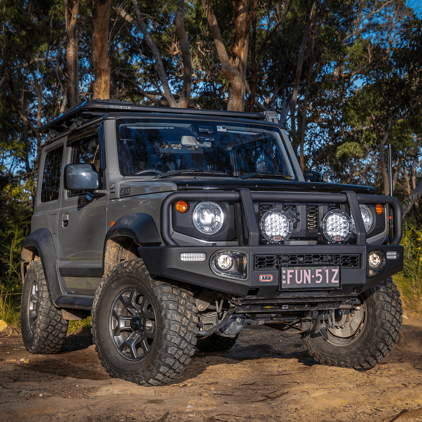 ARB Intensity Solis 21 Spot-Flood Driving Light Kit SJB21SFKIT mounted on a lifted off-road 4x4 with rugged tires and steel bull bar