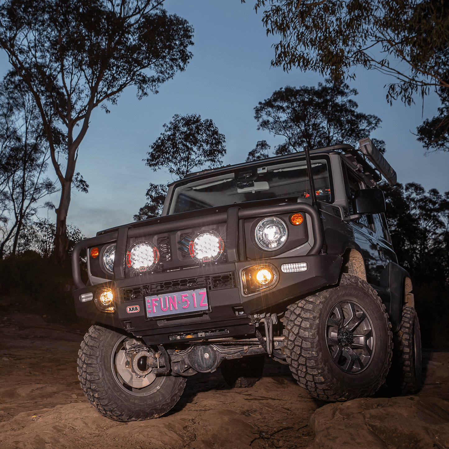 ARB Intensity Solis 21 Spot Driving Light Kit SJB21SKIT mounted on rugged off-road 4x4 with heavy-duty bull bar and aggressive tires