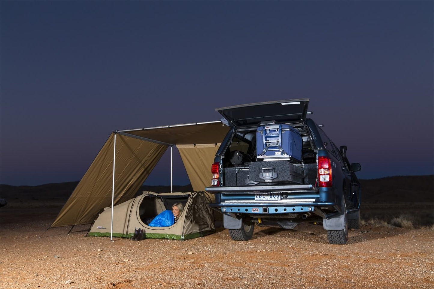 ARB Wind Break Front 1.25M 813301 heavy-duty tan canvas windbreak securing awning on 4x4 off-road vehicle at campsite