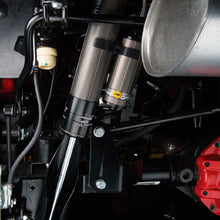 Load image into Gallery viewer, A close up of a vehicle&#39;s engine featuring an Old Man Emu OME Bp-51 Coil Over Front LH BP5190004L shock absorber body and remote reservoir.