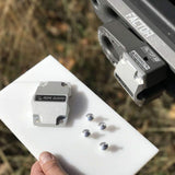 A person is holding a piece of metal on a Factor 55 FlatLink Rope Guard 00380.