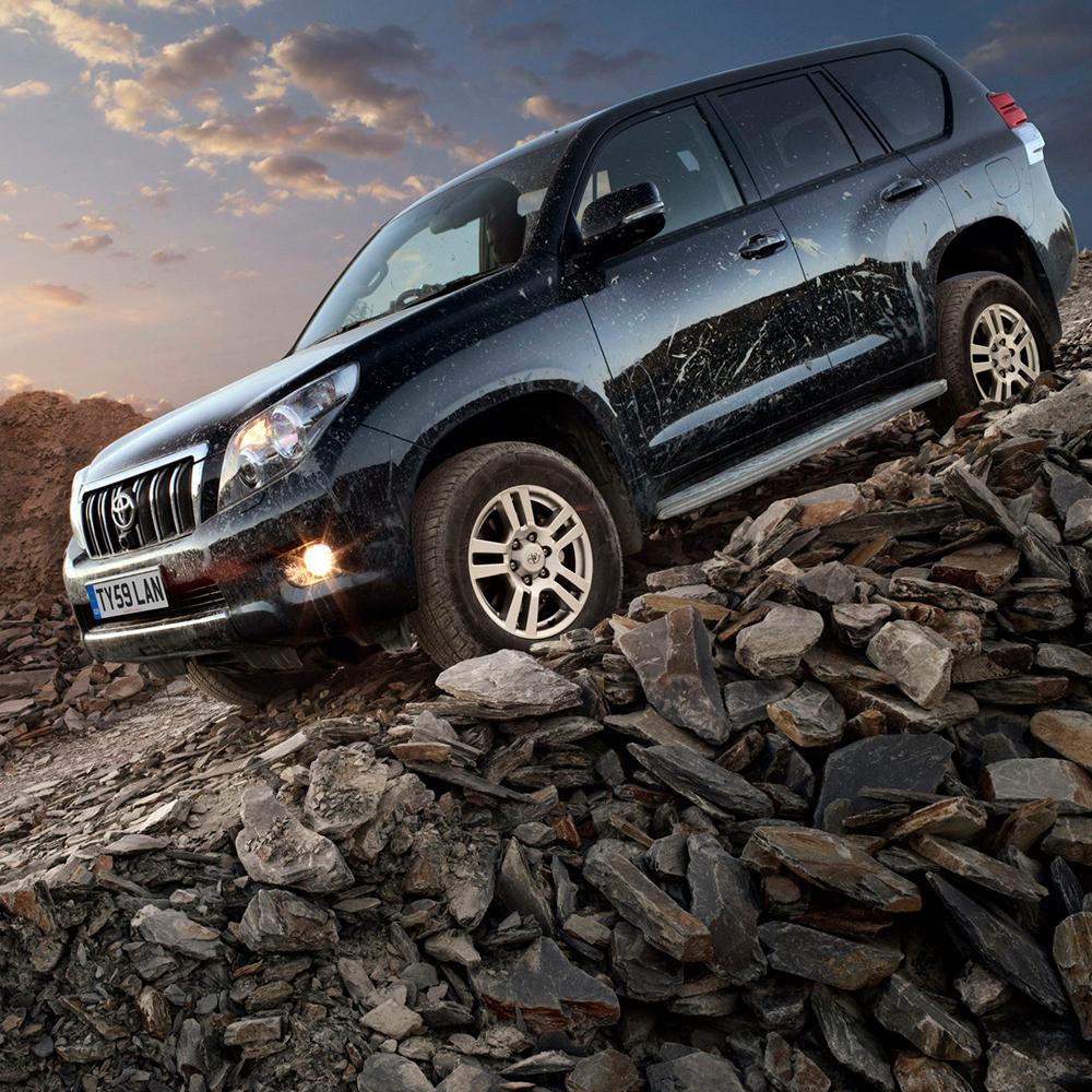 The Old Man Emu Land Cruiser, equipped with the KDSS (Kinetic Dynamic Suspension System), is parked on a rocky hillside.