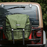 A Trasharoo Spare Tire Trash Bag on the back of a jeep.