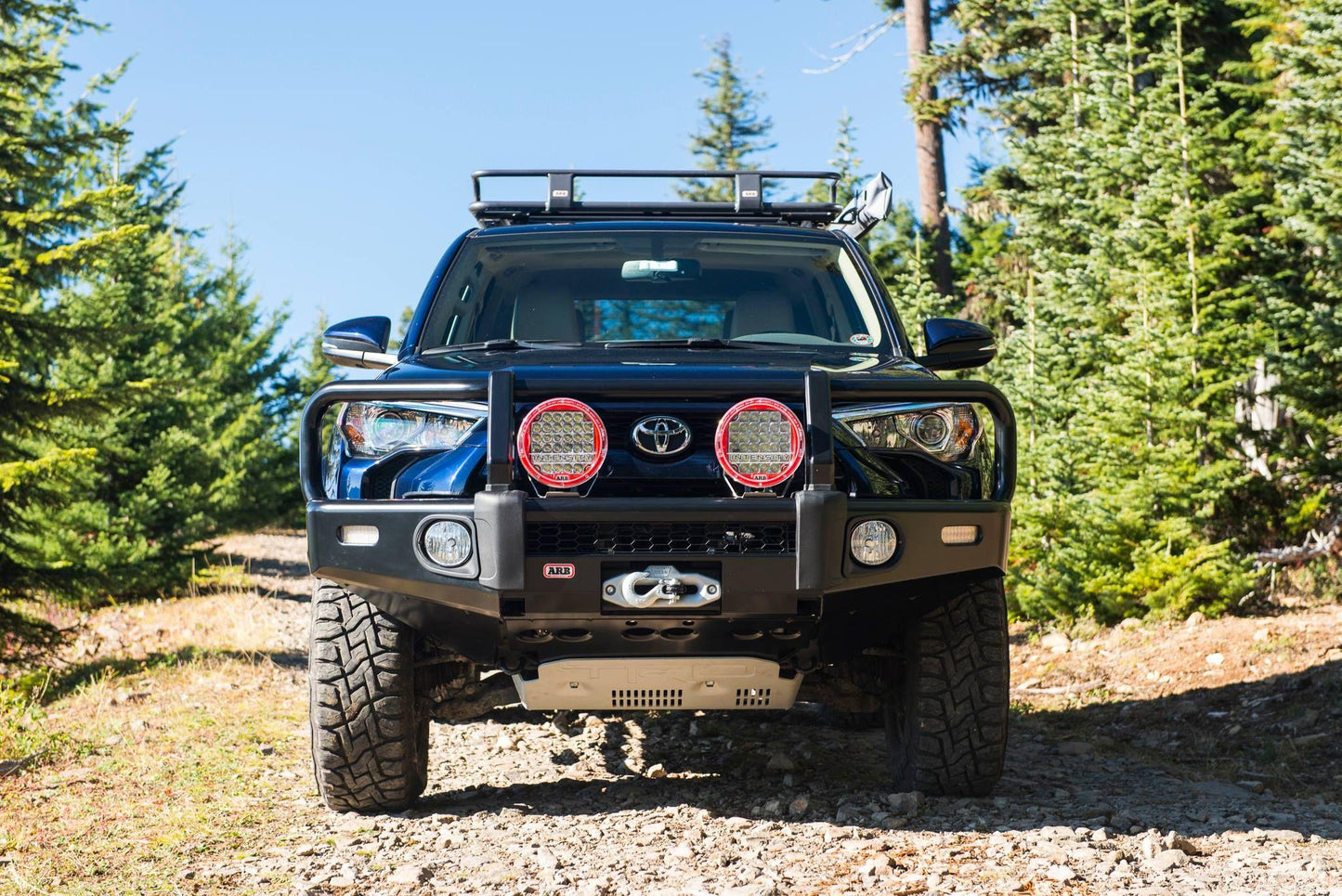 A Toyota Land Cruiser equipped with an ARB Base Rack Deflector fitted with stainless steel hardware.