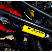 Load image into Gallery viewer, A close up of a yellow and black Old Man Emu 4 Inch Suspension System for (07-18) Jeep Wrangler JK OMEJK4RHD, enhancing off-road drivability.