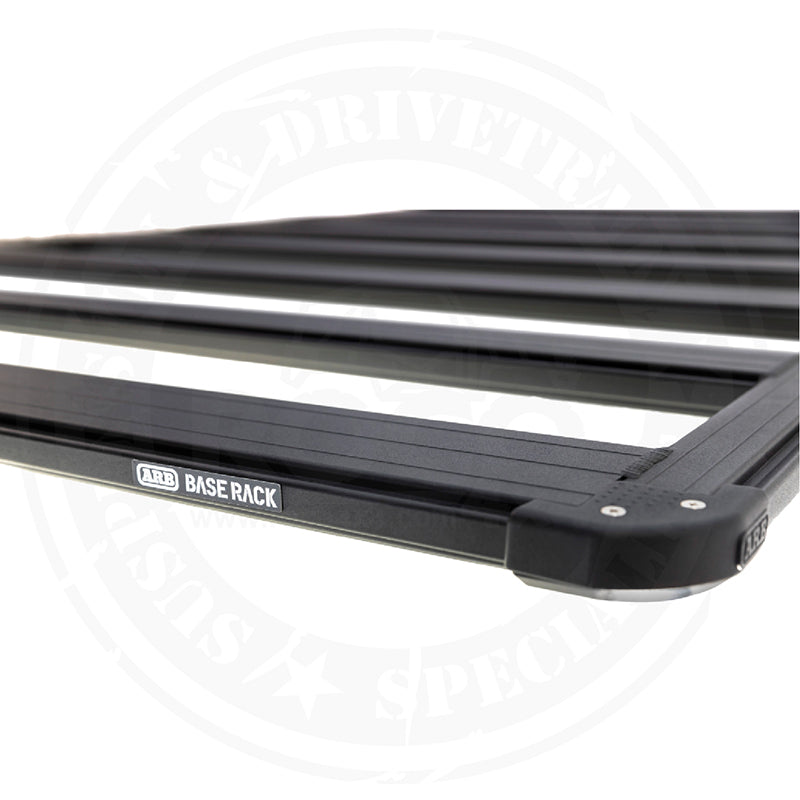 A black Base Rack For Toyota FJ Cruiser 2007-2016 ARB 1770040 with mount brackets on a white background.