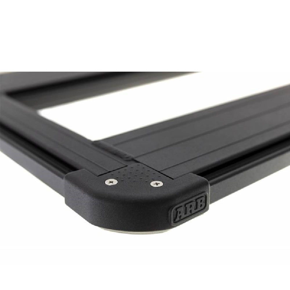 A black Base Rack for Toyota Land Cruiser 71 Series ARB 1770030 with a black handle, perfect for cargo loading and easily compatible with ARB accessories.