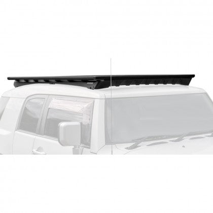 A vehicle-specific black roof rack for a Toyota FJ Cruiser (2007-2016), designed to minimize wind noise, the Base Rack Deflector For Toyota FJ Cruiser (2007-2016) by ARB.