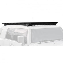 Load image into Gallery viewer, A vehicle-specific black roof rack for a Toyota FJ Cruiser (2007-2016), designed to minimize wind noise, the Base Rack Deflector For Toyota FJ Cruiser (2007-2016) by ARB.