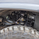 The underside of a jeep with an OME BP-51 3.25 - 3.5 inch Lift Kit for 4Runner (10-23) by Old Man Emu, an adjustable damping suspension system for off-road performance.