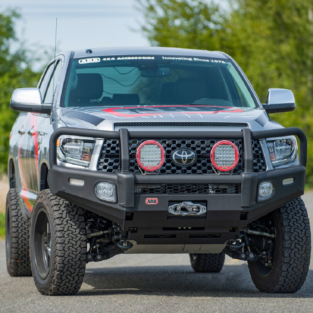 The front end of a Toyota Tacoma with the ARB Summit Front Bumper and Clear Fog Light Cover for Toyota ARB 3500680.
