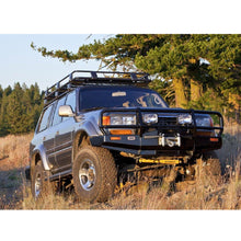 Load image into Gallery viewer, The Old Man Emu Land Cruiser, renowned for its exceptional off-road performance, is parked in a grassy area. With its OME BP-51 3 inch Lift Kit for LandCruiser 80 &amp; 105 Series (90-07) shock absorbers and adjustable damping technology, this powerful vehicle delivers