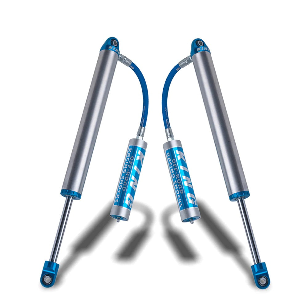 A pair of King Shocks Rear 2.5 Remote Reservoir Shocks (PAIR) for Toyota 4Runner, FJ Cruiser, Landruiser 200 Series on a white background.