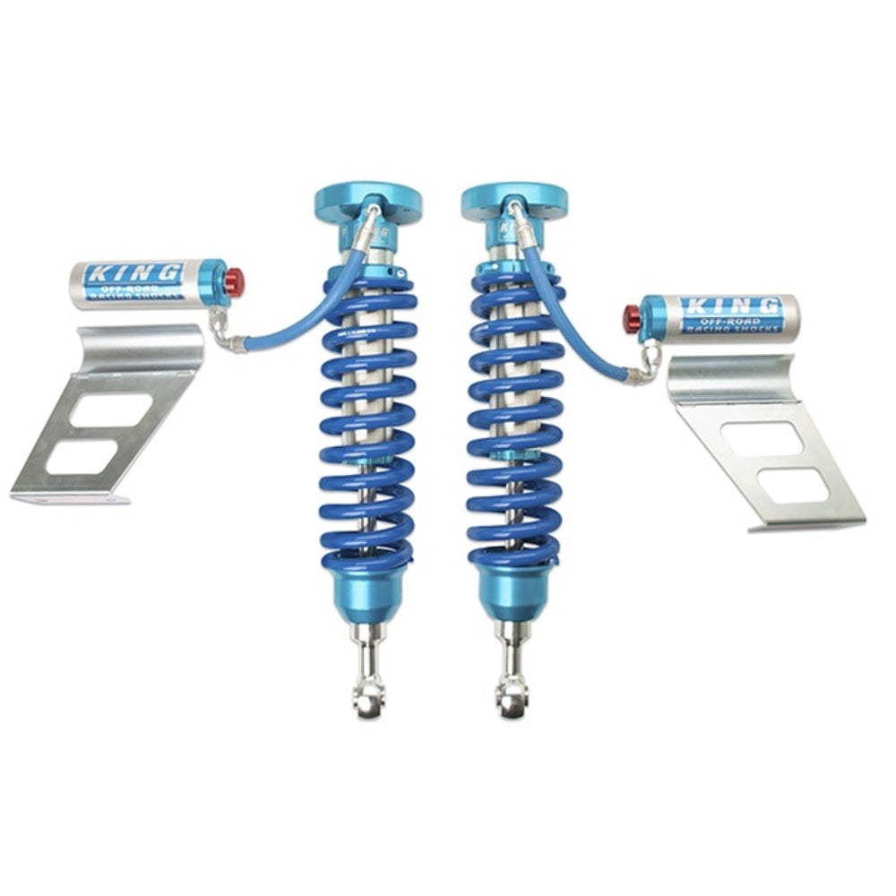 A pair of King Shocks 2.5 Front Coilover w/Remote Reservoir w/Adjuster for Toyota Tundra 2007-ON, on a white background, showcasing their exceptional suspension system.