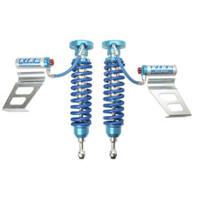 Load image into Gallery viewer, A pair of King Shocks 2.5 Front Coilover w/Remote Reservoir w/Adjuster for Toyota Tundra 2007-ON, on a white background, showcasing their exceptional suspension system.