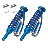 A pair of King Shocks Front 2.5 Remote Reservoir Coilover (PAIR) for Toyota 4Runner w/ KDSS (10-ON), part of a bolt-on suspension system, on a white background.