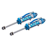 A pair of King Shocks Rear 2.5 Remote Reservoir Shocks (PAIR) for Toyota Landruiser 200 Series with a bolt-on suspension system on a white background.