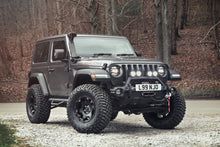 Load image into Gallery viewer, The Fox Racing FOX 3.5 inch Jeep Wrangler JL 2Door Lift Kit (Medium Load) FOX Suspension FOXJL2D-1822 Fits Jeep Wrangler JL 2 Door, with larger tires, is parked in the woods.