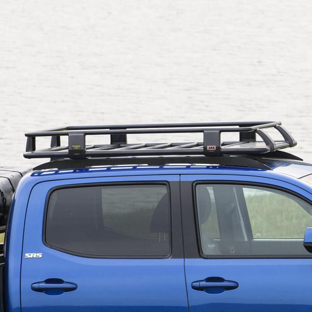 A blue ARB Toyota Tacoma with a Steel Flat Rack Kit 52” x 44” providing secure storage.