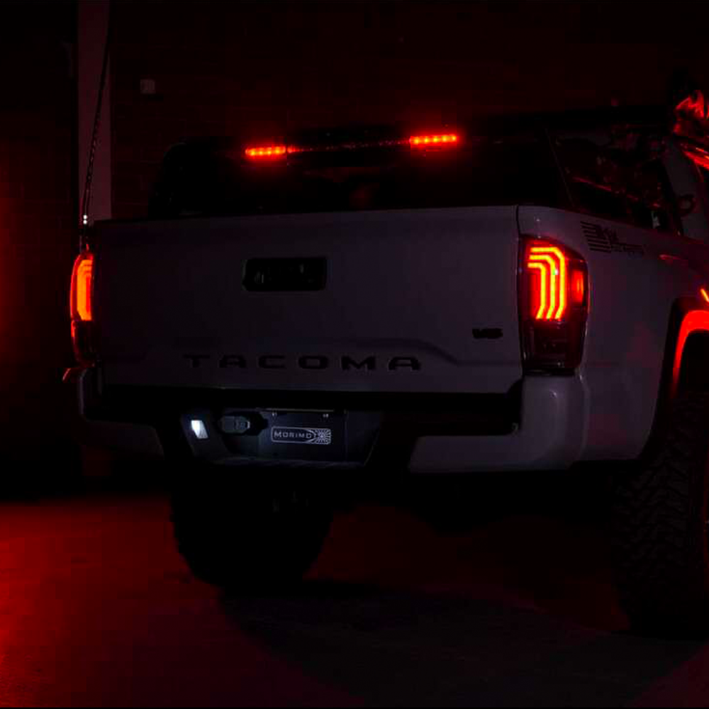 A Morimoto XB Led Tails LF702 For Toyota Tacoma (2016 - 2022) truck is lit up at night.