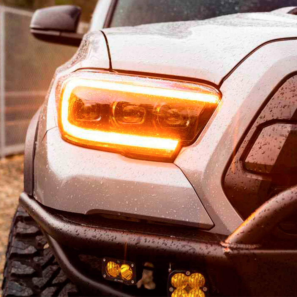 A close up of the front end of a 2019 Toyota Tacoma with Morimoto XB LED Headlights Amber DRL LF530.2-A-ASM.