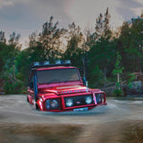 A robust red Old Man Emu Land Rover effortlessly maneuvers through a watery terrain, showcasing its exceptional ground clearance with the OME 2 inch Lift Kit for Land Rover Defender 110 (85-17).