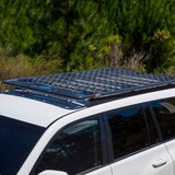 A white ARB SUV with a secure storage compartment and an ARB fitting kit for the solar panel on top of it.