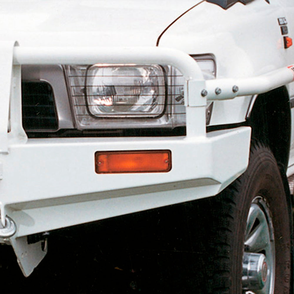 A close up of a white Toyota 4Runner (1989-1997) Flared Model - non-Airbag with a sturdy ARB Winch Bull Bar 3414060 made of high-quality steel, emphasizing its durability and providing superior protection.