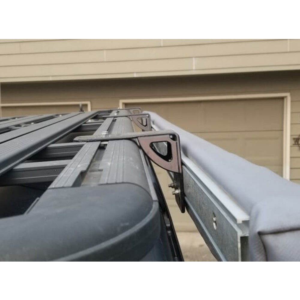 An ARB Awning Bracket 50mm(2) With Gusset 813402, a corrosion-resistant roof rack with roof bars attached to the side of a car.