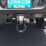 The rear bumper of a jeep has a Factor 55 HitchLink 2.0in Silver 00020-05 attached to it.