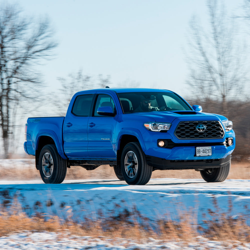 Product Description: The blue Old Man Emu Toyota Tacoma, equipped with progressive distribution technology, glides effortlessly down a snowy road. Its optimized performance ensures a smooth and steady ride, embracing the essence of keywords for effective SEO.